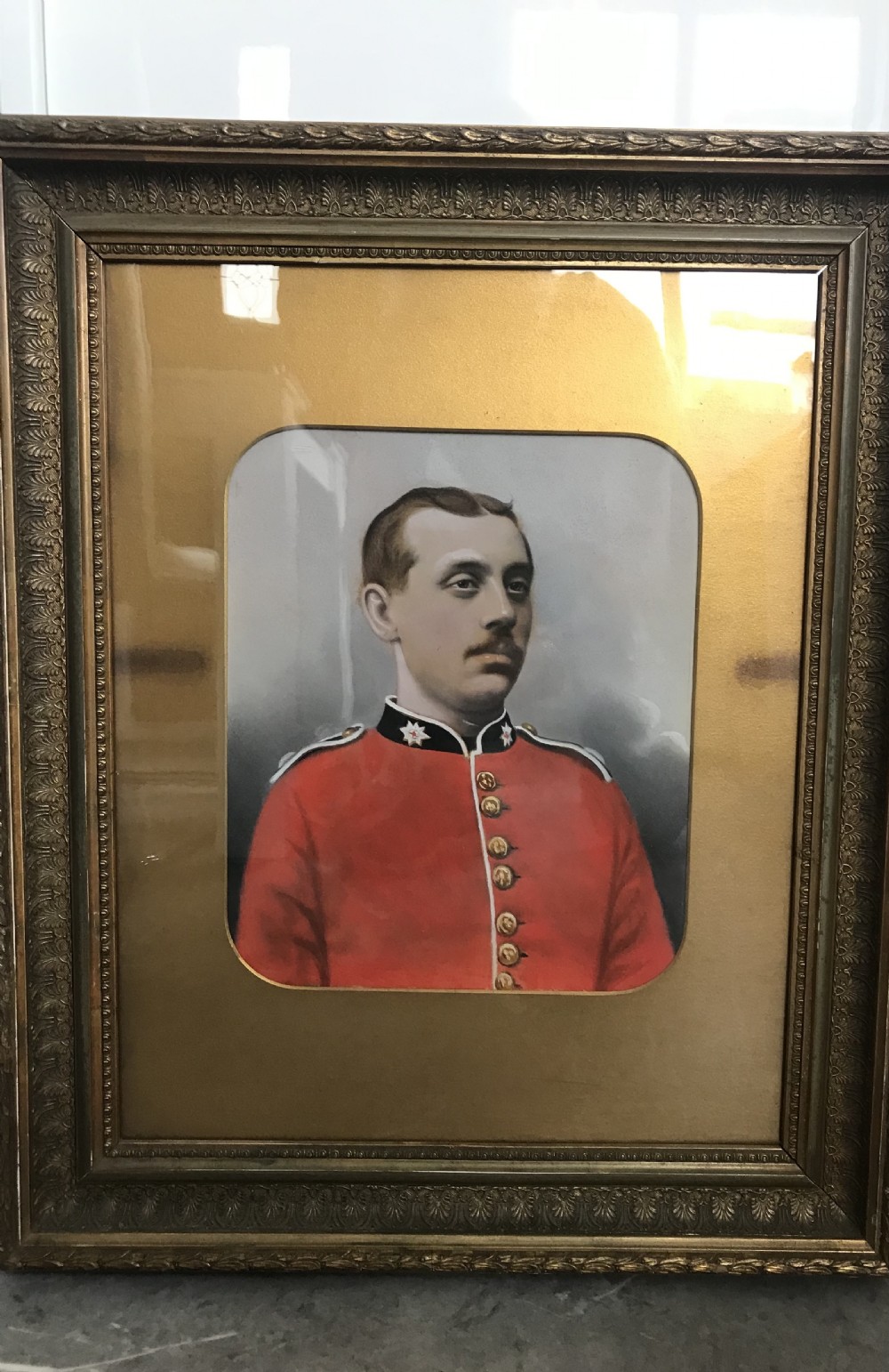 A 19th-century framed oil portrait of a Coldstream Guardsman wearing a scarlet red uniform tunic with gold buttons and a black collar. View II