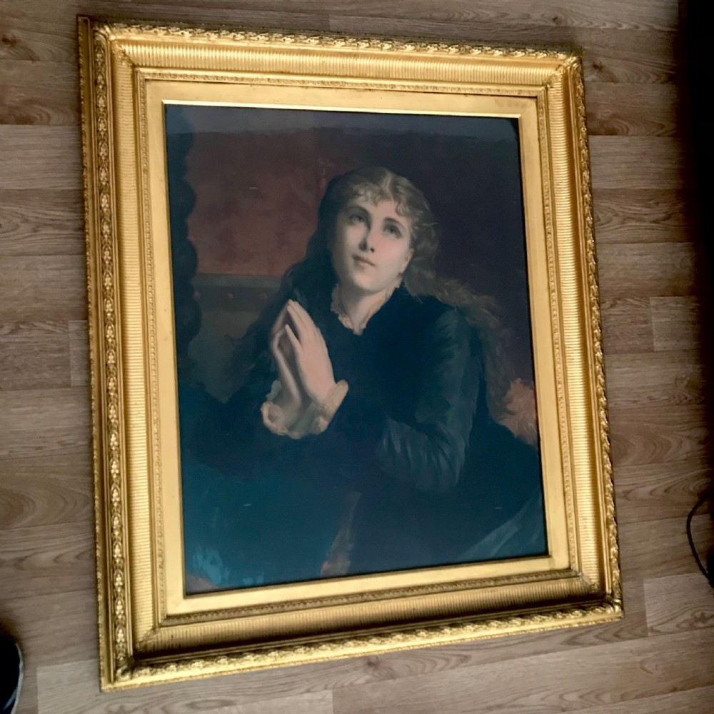 A 19th-century oleograph portrait of Mary Magdalene with clasped hands in prayer, presented inside a deep moulded gold frame under glass. View IV