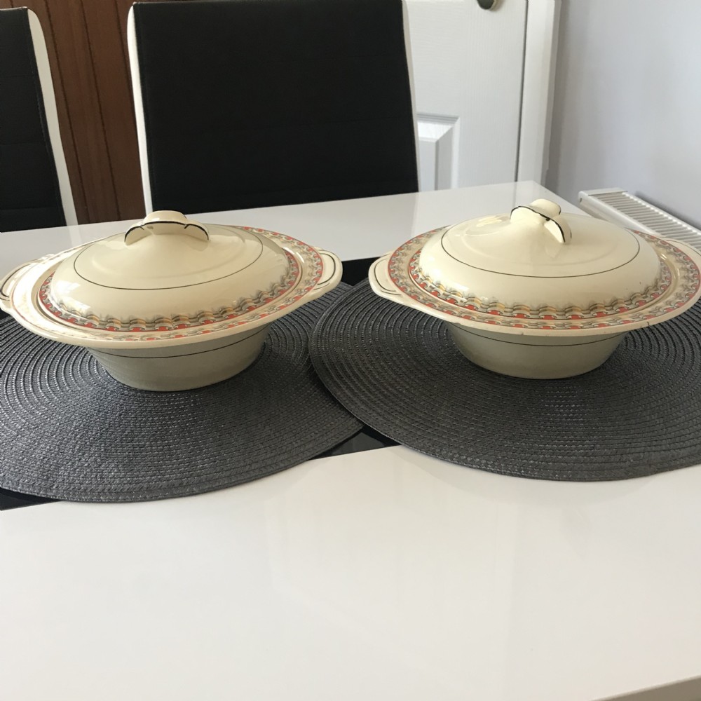 An Art Deco cream earthenware lidded vegetable tureen featuring a geometric pattern in orange and grey along the rim. View IX