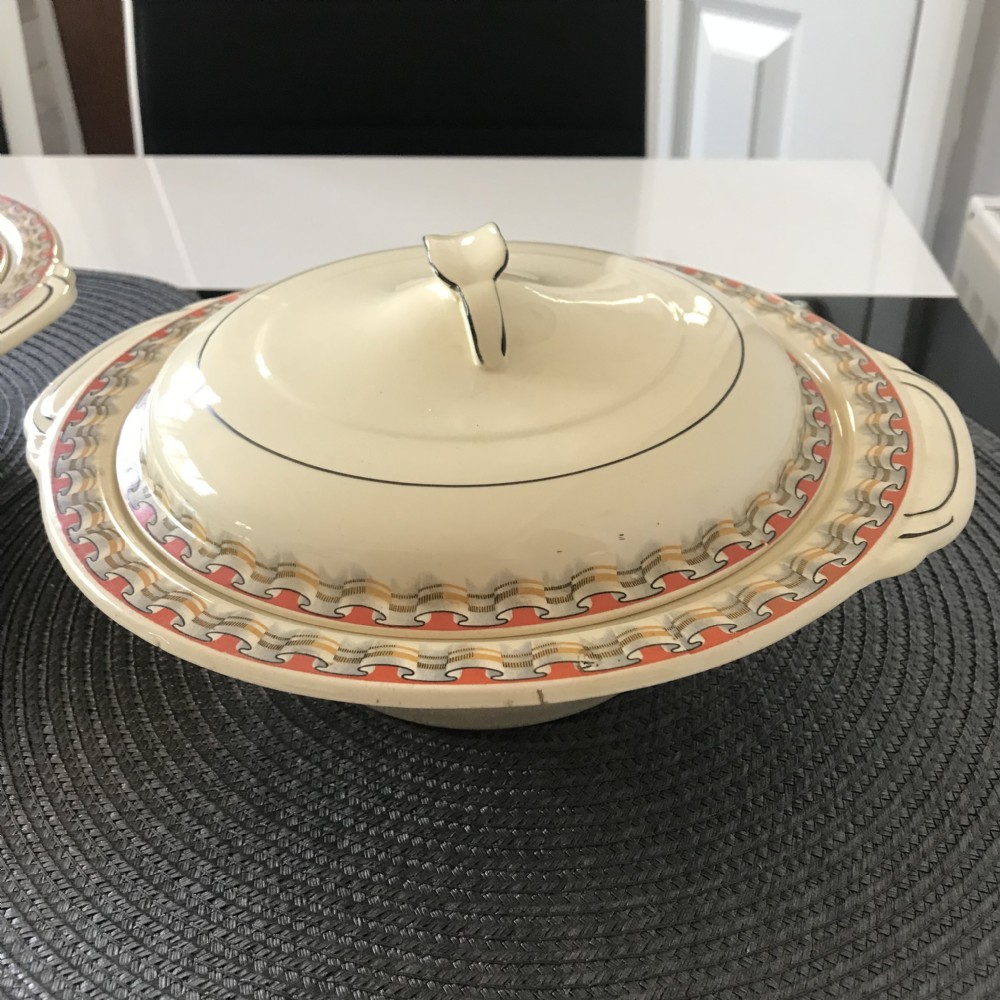 An Art Deco cream earthenware lidded vegetable tureen featuring a geometric pattern in orange and grey along the rim. View XIV