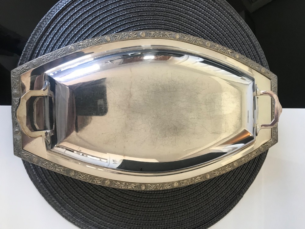 A boat-shaped silver-plated vegetable tureen with a fitted lid and side handles. View II