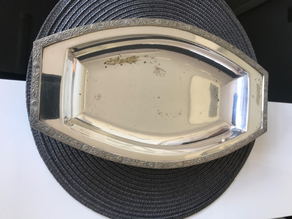 A boat-shaped silver-plated vegetable tureen with a fitted lid and side handles. View IV