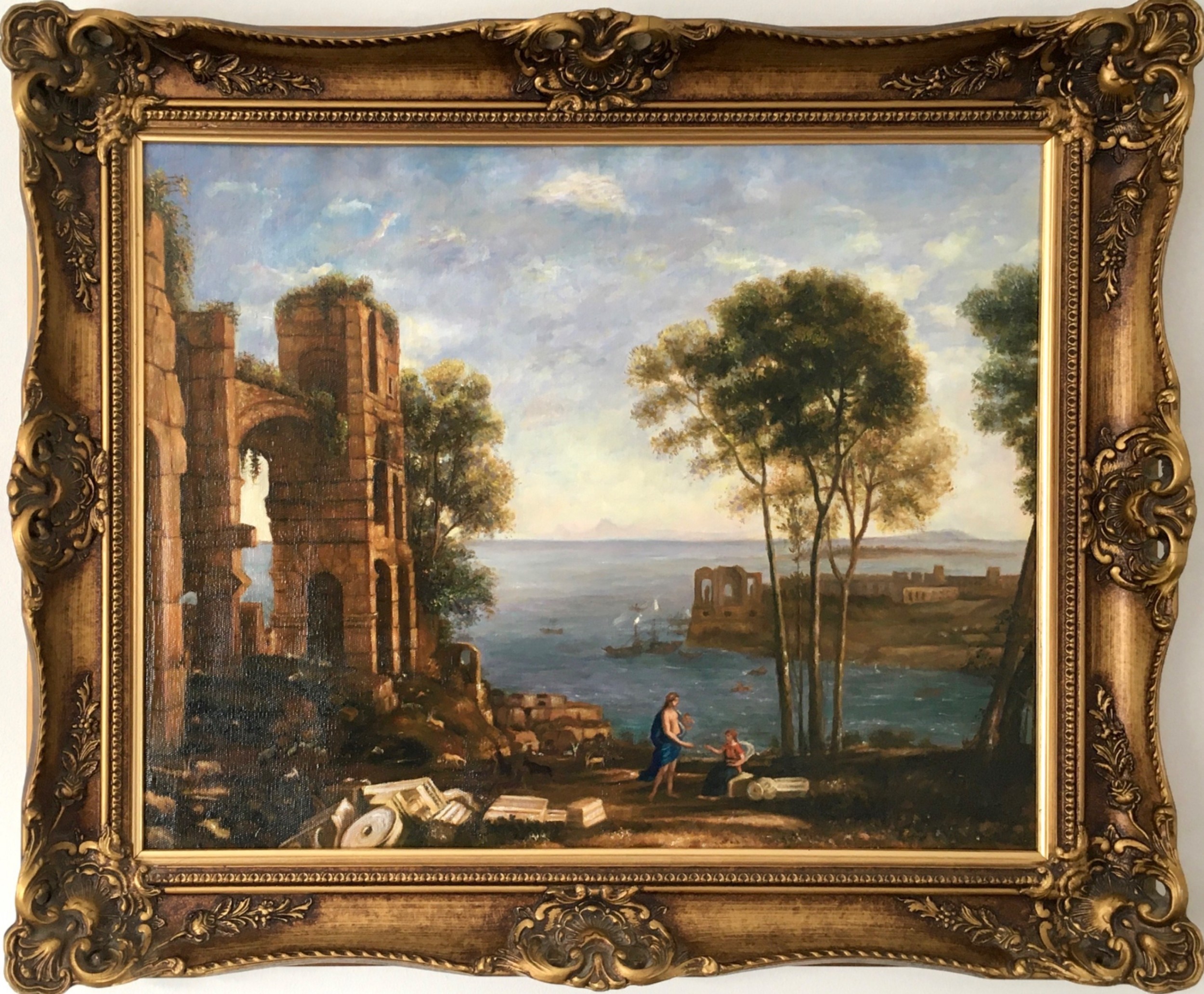 An oil painting on canvas depicting classical Italian architectural ruins along a Mediterranean coastline within an ornate gold gilt frame.