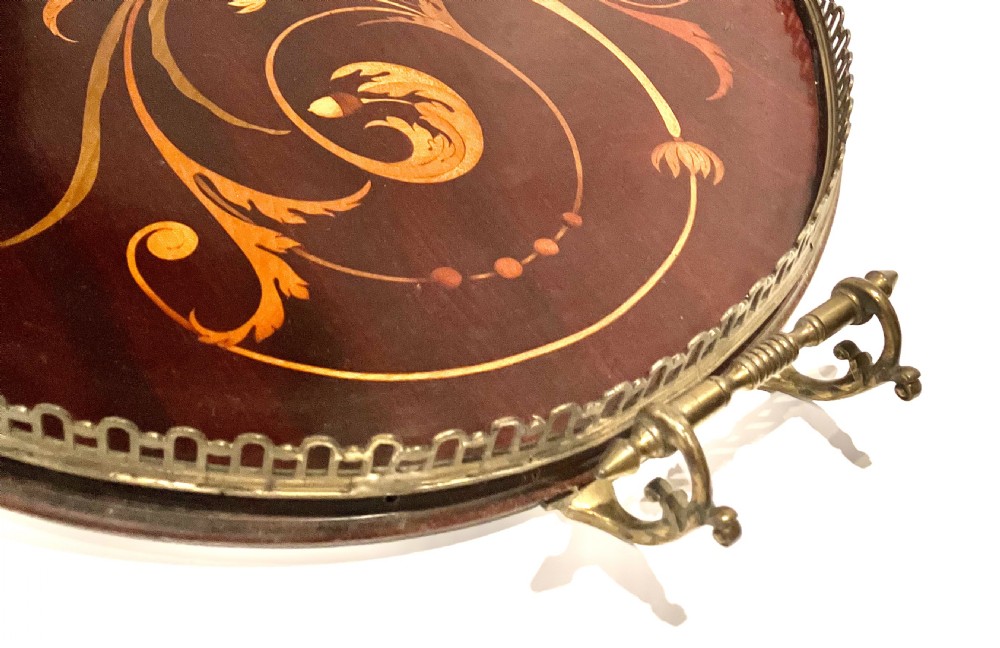 A crescent-shaped mahogany tray featuring inlaid botanical marquetry, a central urn motif, and a pierced brass gallery rim with handles. View IV