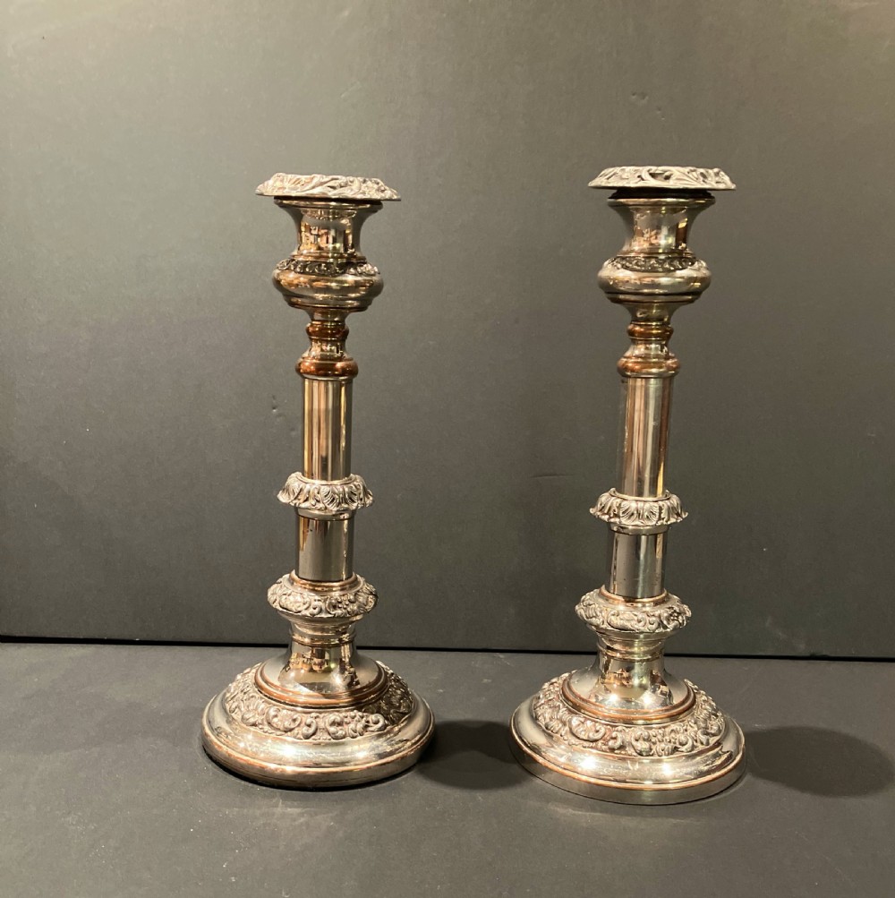A pair of silver-plated telescopic candlesticks featuring circular embossed bases and adjustable stems. View VI