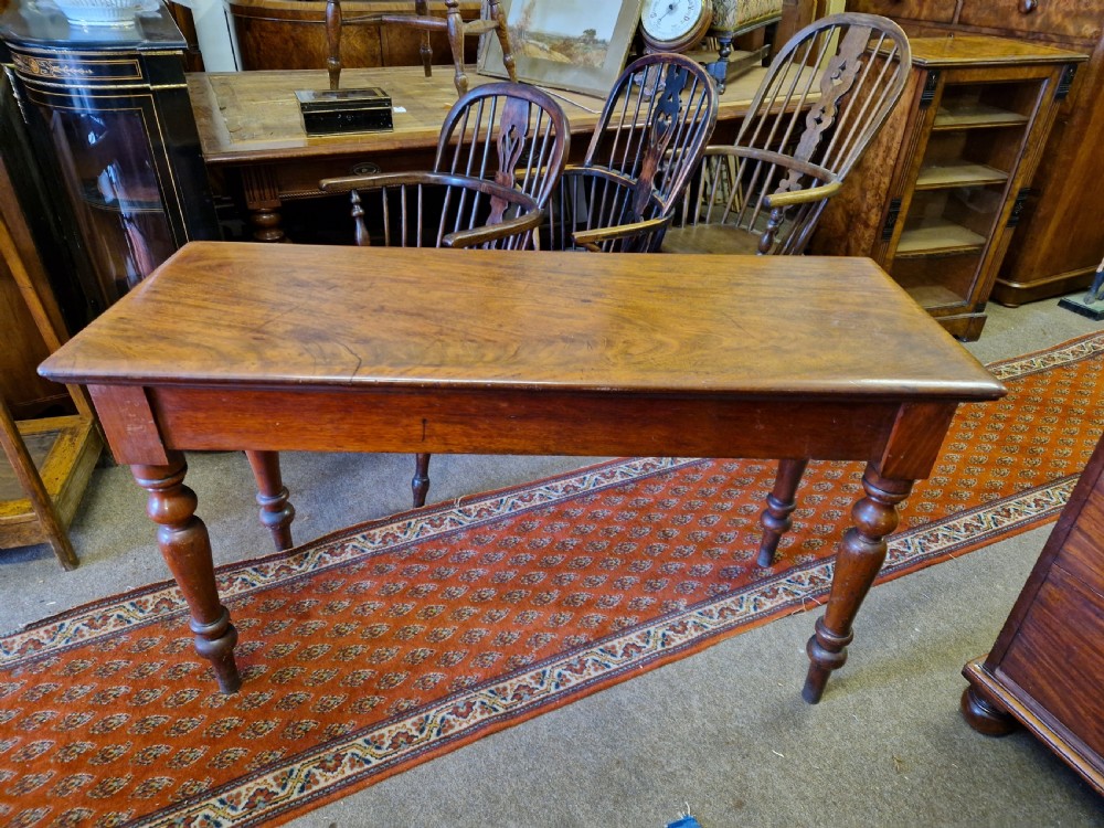 A Victorian mahogany hall side table featuring a plain rectangular top, a solid apron, and four turned baluster legs. View II