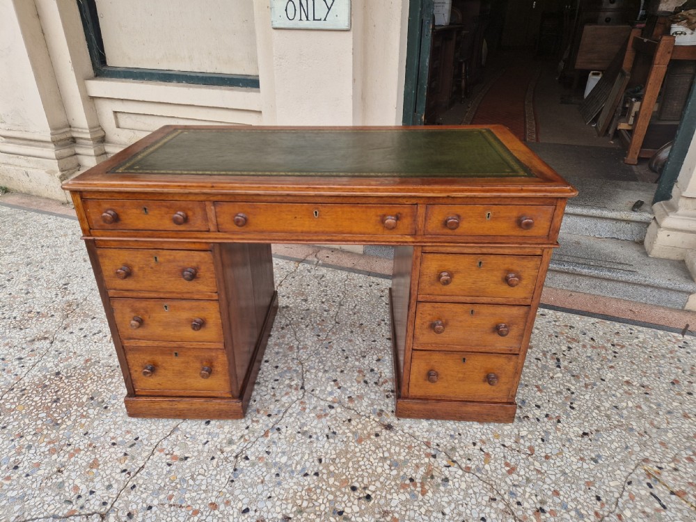 ANTIQUE OAK MAPLE AND CO PEDESTAL DESK .