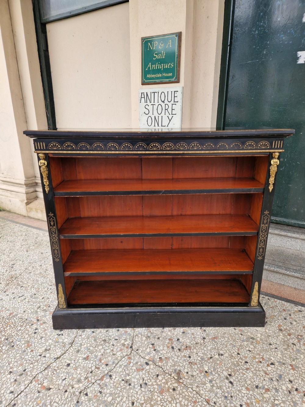   A VICTORIAN EBONISED OPEN BOOKCASE BY EDWARDS AND ROBERTS 