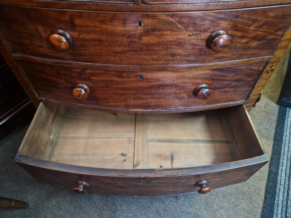 A Georgian mahogany bow front chest of drawers featuring two short over three long graduated drawers with turned wooden knobs and delicate geometric inlay. View XIII