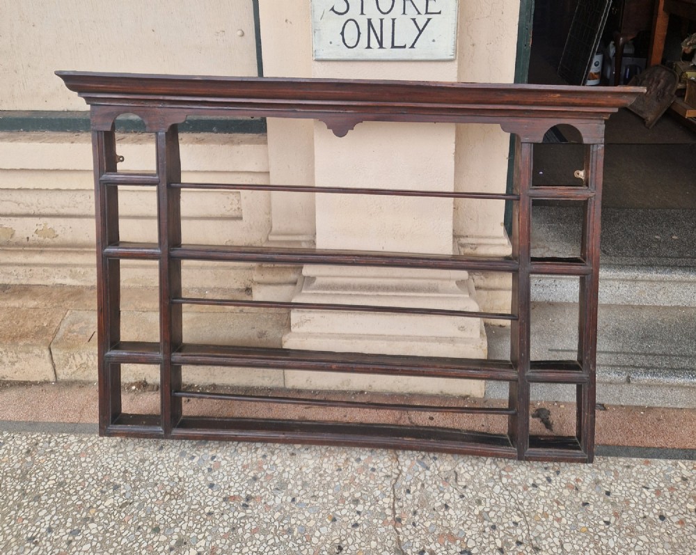 A dark-stained antique oak delft wall rack featuring open shelves, side compartments, and a heavy moulded cornice. View II