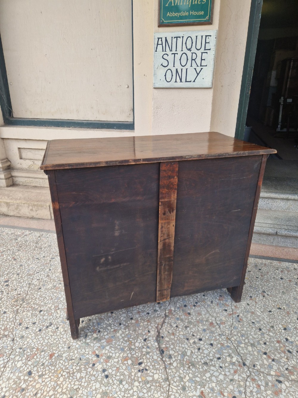 An Edwardian solid oak chest of drawers with two short over two long drawers fitted with decorative brass handles. View VIII