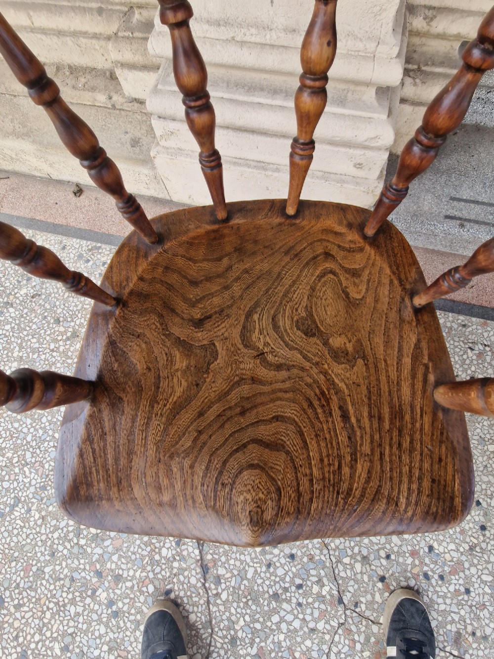 A pair of antique warm brown ash and elm captains armchairs featuring curved horseshoe backrests, turned spindles, shaped saddle seats, and turned legs. View VII