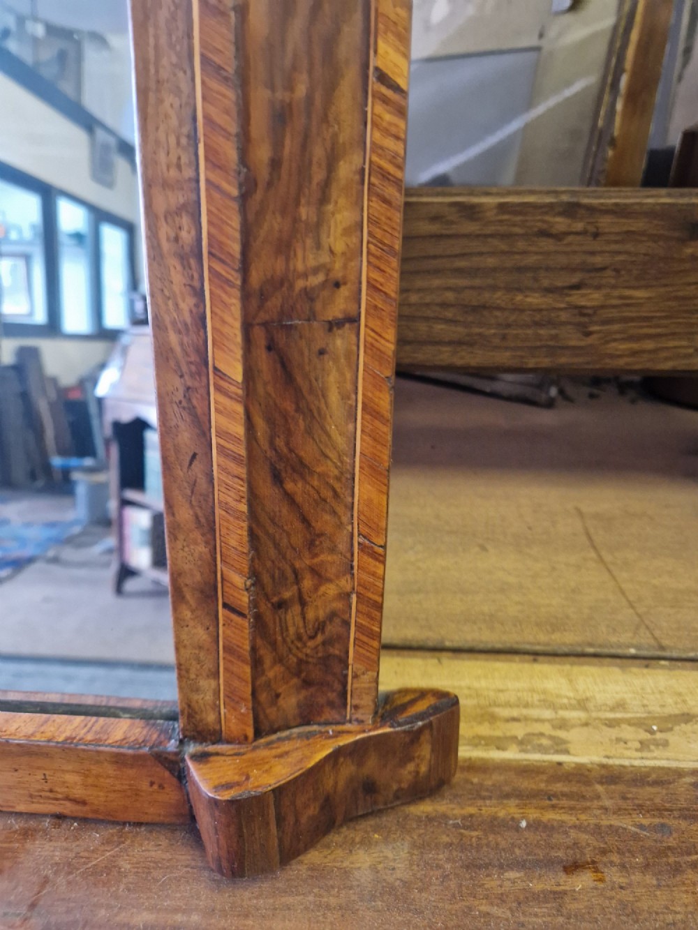 A Victorian burr walnut overmantel mirror featuring a curved arched top frame resting on flat moulding blocks. View IV
