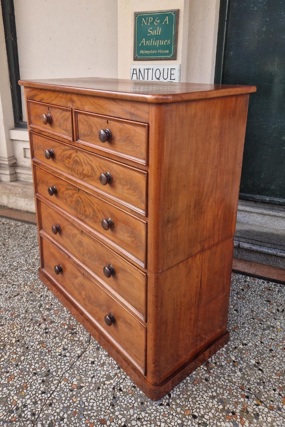 A tall Victorian mahogany chest of drawers featuring two short upper drawers above four long graduating drawers with turned wooden knobs and a plinth base. View II