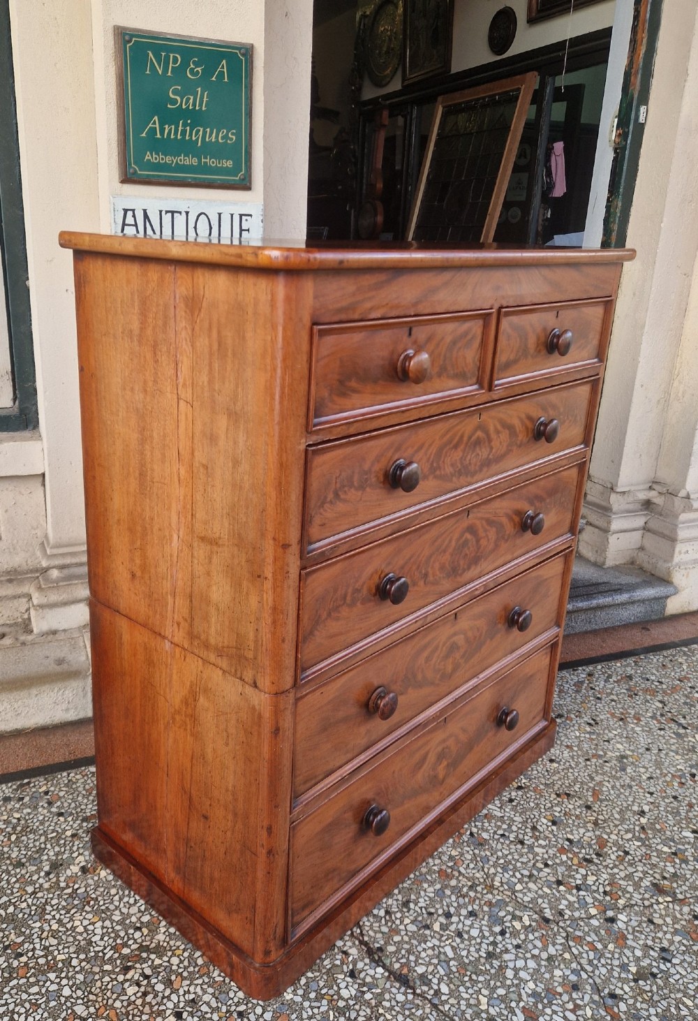 A tall Victorian mahogany chest of drawers featuring two short upper drawers above four long graduating drawers with turned wooden knobs and a plinth base. View III