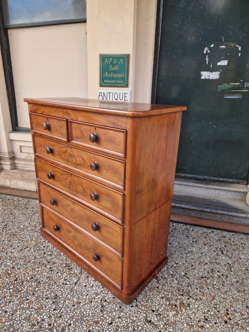 A tall Victorian mahogany chest of drawers featuring two short upper drawers above four long graduating drawers with turned wooden knobs and a plinth base. View V