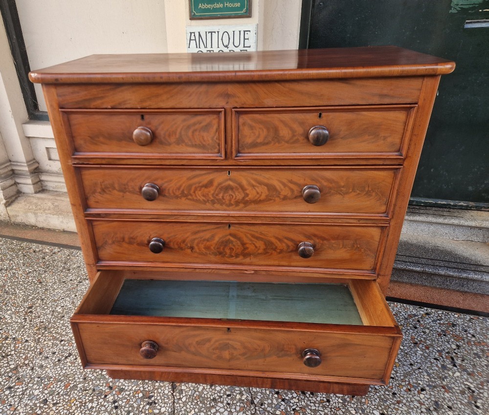 A tall Victorian mahogany chest of drawers featuring two short upper drawers above four long graduating drawers with turned wooden knobs and a plinth base. View IX
