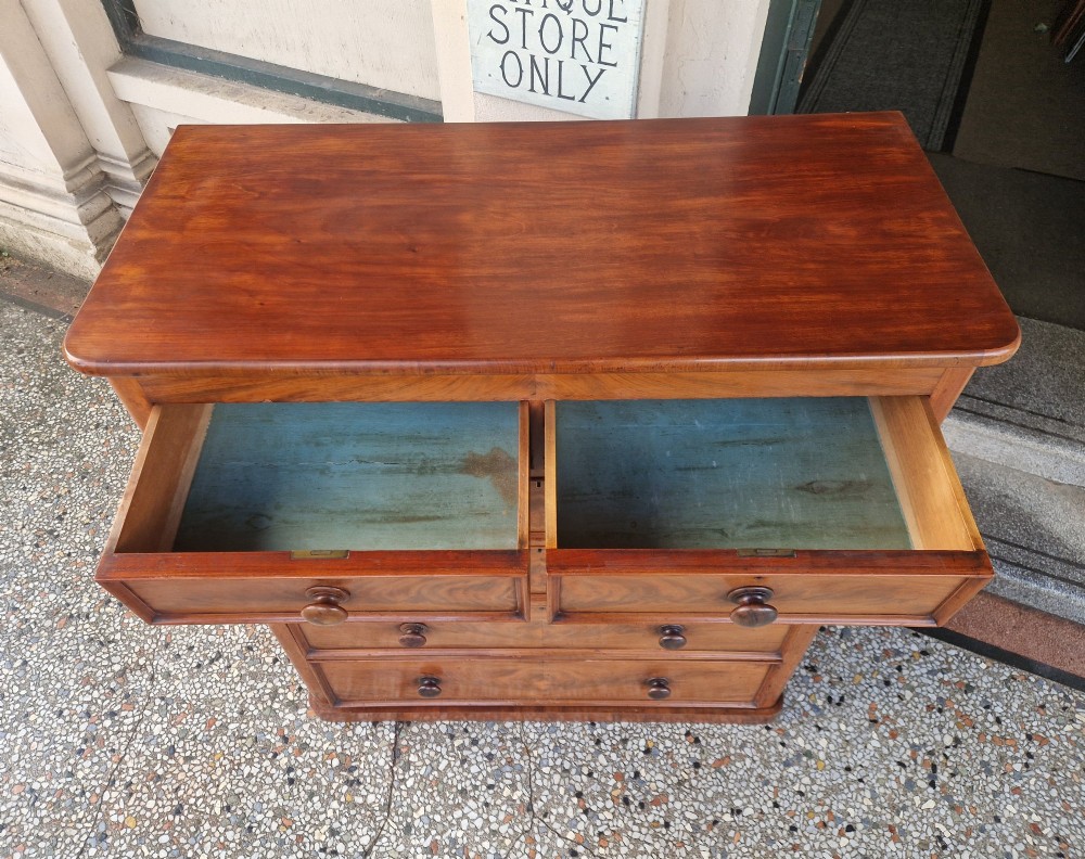 A tall Victorian mahogany chest of drawers featuring two short upper drawers above four long graduating drawers with turned wooden knobs and a plinth base. View X