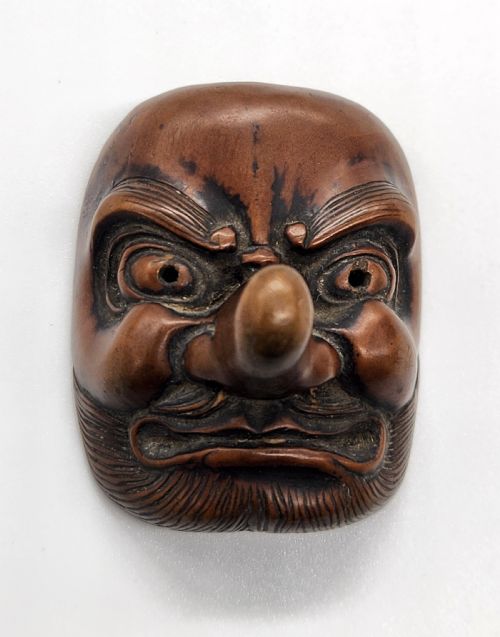 AN AMUSING WOOD MASK NETSUKE OF A LONGNOSED TENGU EDO PERIOD