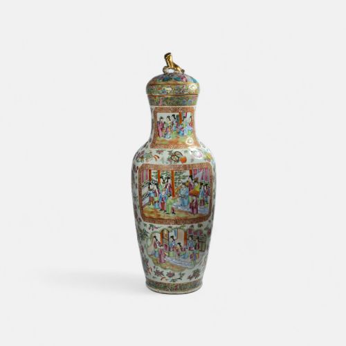 fig 2. A 19th-century Cantonese Rose Mandarin porcelain baluster vase decorated with narrative figure panels, floral enamel borders, and a domed cover topped with a gilt foo dog finial.