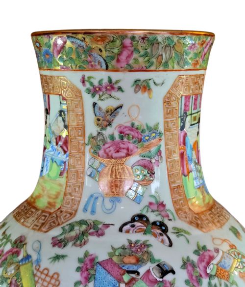 fig 4. A 19th-century Cantonese Rose Mandarin porcelain baluster vase decorated with narrative figure panels, floral enamel borders, and a domed cover topped with a gilt foo dog finial.