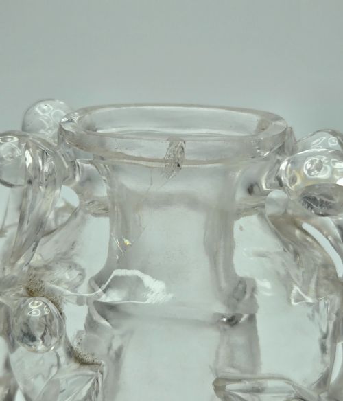 fig 3. A 19th-century Chinese carved clear rock crystal snuff bottle featuring openwork prunus branches around the body and a smooth matching stopper.