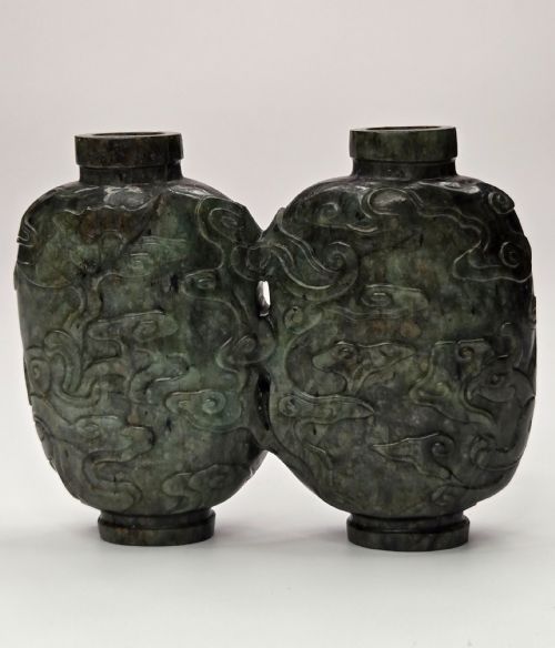 fig 3. A carved double-lobed spinach-green jade snuff bottle decorated with raised cloud motifs and twin cylindrical rims.