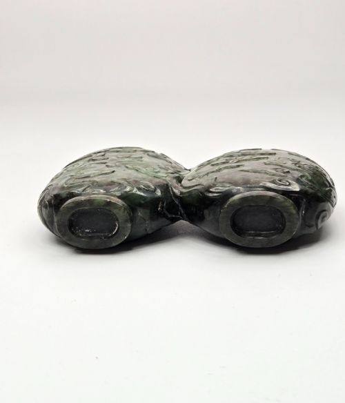 fig 4. A carved double-lobed spinach-green jade snuff bottle decorated with raised cloud motifs and twin cylindrical rims.