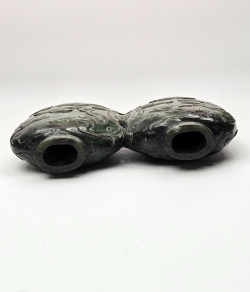 fig 5. A carved double-lobed spinach-green jade snuff bottle decorated with raised cloud motifs and twin cylindrical rims.