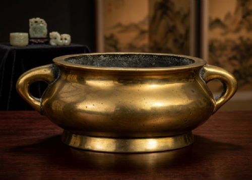 fig 3. An 18th-century Chinese bronze censer featuring a rounded bombe body, flared rim, splayed foot ring, and two loop handles.