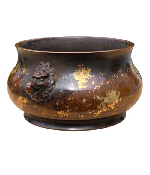 fig 9. A dark brown cast bronze incense burner featuring irregular gold splash decoration and detailed beast mask handles on either side.