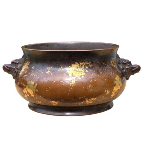 fig 10. A dark brown cast bronze incense burner featuring irregular gold splash decoration and detailed beast mask handles on either side.
