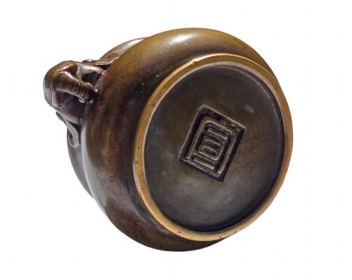 fig 3. A miniature dark bronze censer featuring a rounded body, twin elephant head handles with curved trunks, and a circular raised footring.