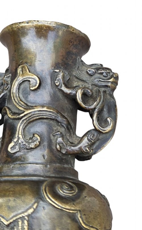 fig 4. A patinated cast bronze Chinese vase featuring stylised dragon-head handles and raised Yingluo beaded tassels.