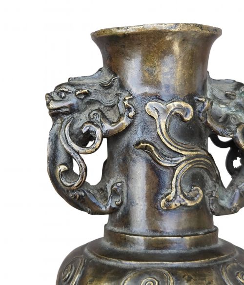fig 8. A patinated cast bronze Chinese vase featuring stylised dragon-head handles and raised Yingluo beaded tassels.