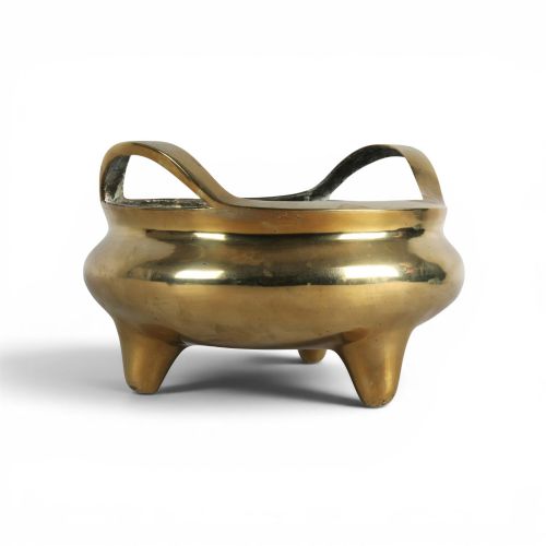 fig 4. A heavy gold-toned cast bronze tripod censer featuring two upright loop handles and conical feet.