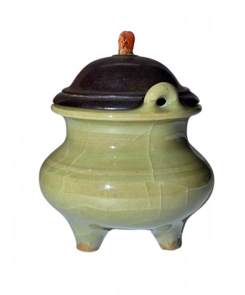 fig 3. A miniature pale celadon green tripod censer with a distinct crackle glaze, fitted with a dark wood cover and a carved red coral finial.