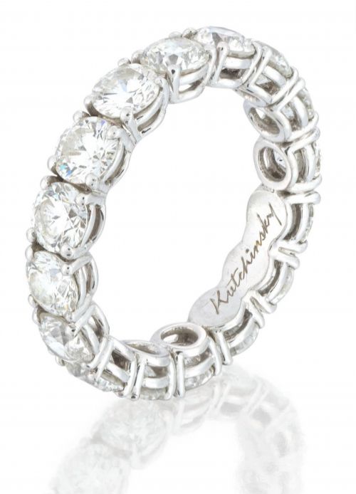 fig 2. A platinum full eternity ring set with round brilliant diamonds, displayed inside its original black leather Kutchinsky box.