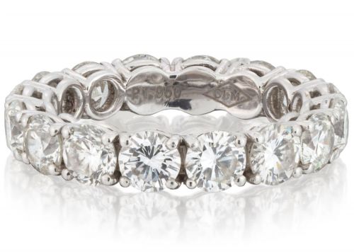 fig 3. A platinum full eternity ring set with round brilliant diamonds, displayed inside its original black leather Kutchinsky box.
