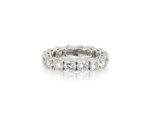 fig 5. A platinum full eternity ring set with round brilliant diamonds, displayed inside its original black leather Kutchinsky box.