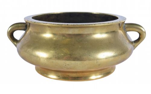 fig 1. An 18th-century cast bronze incense burner featuring a compressed rounded body, flared rim, two loop handles, and a burnished golden patinated finish.