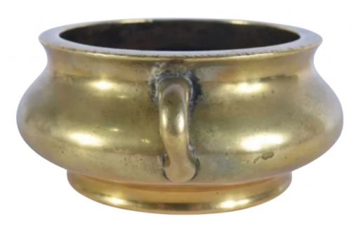 fig 3. An 18th-century cast bronze incense burner featuring a compressed rounded body, flared rim, two loop handles, and a burnished golden patinated finish.