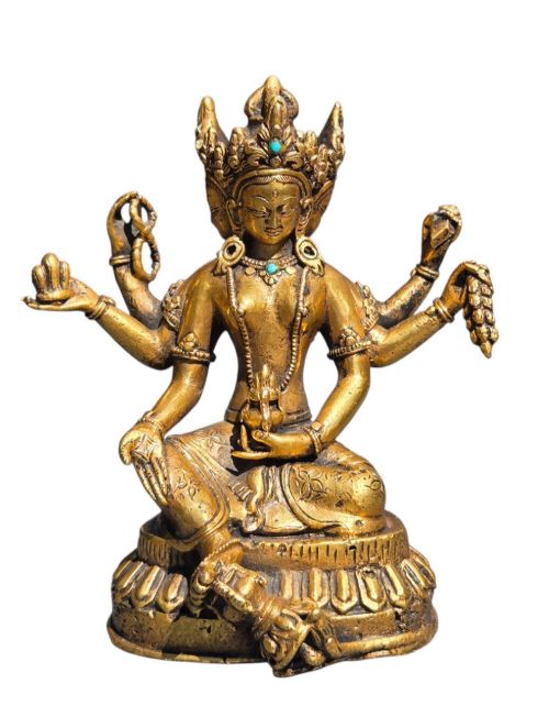 fig 1. An early 19th-century gilt bronze multi-armed deity figure seated on a lotus base with turquoise stone inlays in the crown.