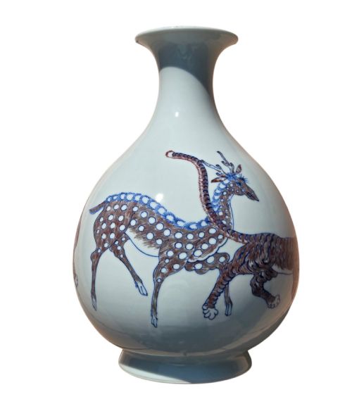 fig 2. A white porcelain garlic-mouth vase featuring underglaze blue and copper-red painted depictions of mythical beasts.