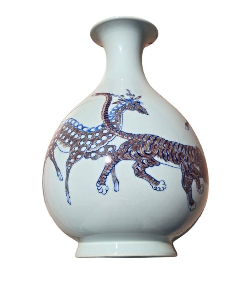 fig 4. A white porcelain garlic-mouth vase featuring underglaze blue and copper-red painted depictions of mythical beasts.