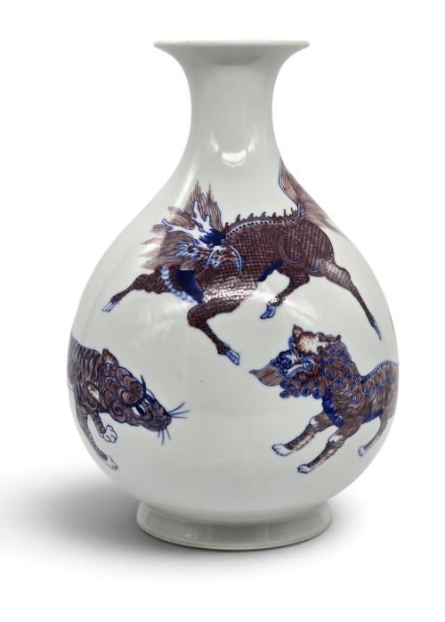 A Fine and Finely Painted Underglaze Blue and Copper-red 'Mythical Beasts' Garlic-mouth Vase ​Late Qing to Early Republic Period