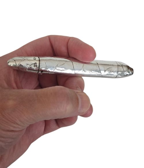 fig 1. A Victorian sterling silver vesta case crafted in the shape of a double-ended cigar with engraved leaf textures.