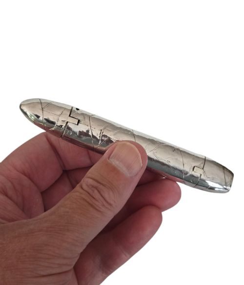 fig 3. A Victorian sterling silver vesta case crafted in the shape of a double-ended cigar with engraved leaf textures.