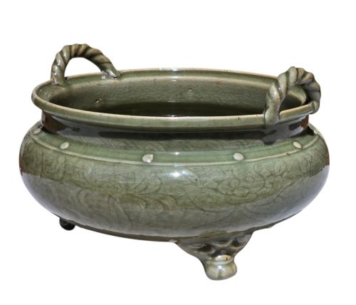 fig 4. A green glazed Longquan celadon tripod censer with carved floral scrollwork beneath the glaze, twin rope-twist handles, and three mask feet.