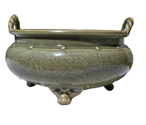 fig 8. A green glazed Longquan celadon tripod censer with carved floral scrollwork beneath the glaze, twin rope-twist handles, and three mask feet.